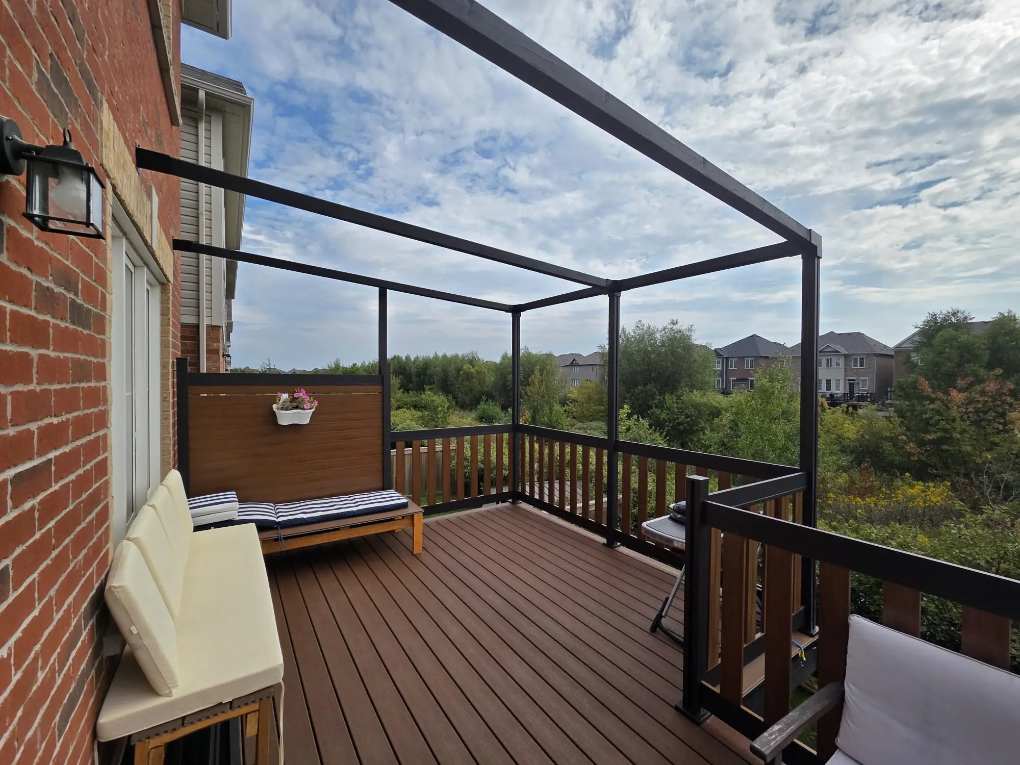 Aluminum fence and railing system installed on a residential deck, showing material durability versus composite alternatives