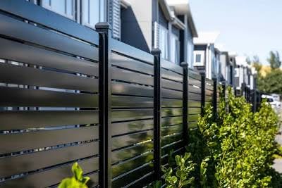 Black ornamental aluminum fence by PrimeAlux showing wrought iron look without rust or maintenance
