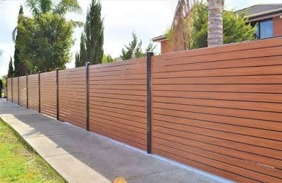 Wood look aluminum fence panel showing natural walnut grain finish