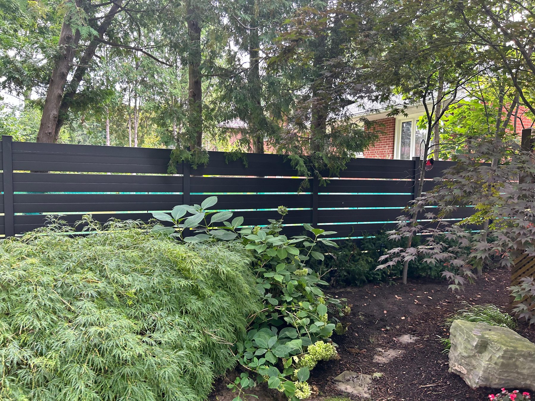 Black semi-privacy aluminum fence panel showing post and panel connection detail for hardware matching
