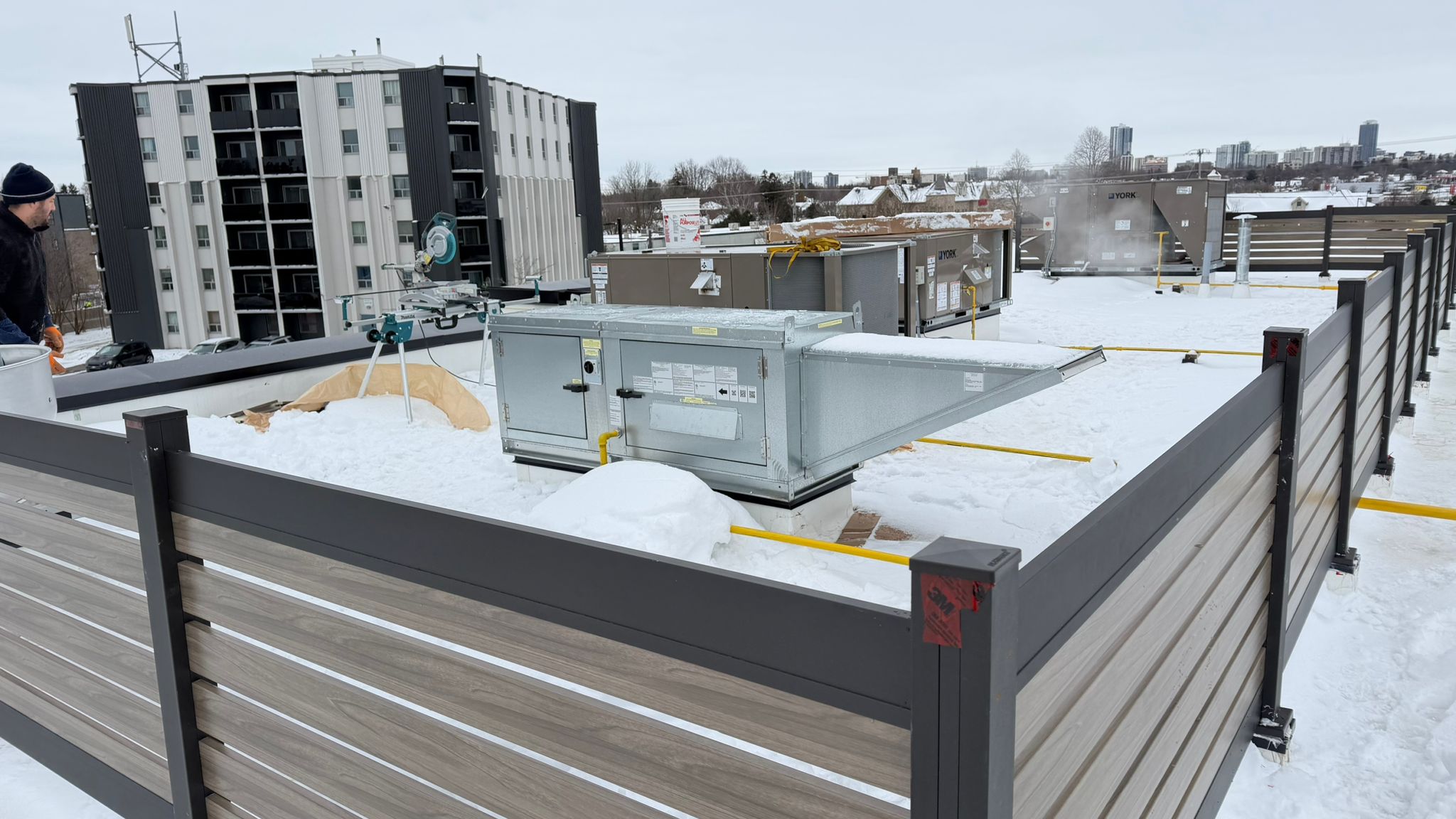 Commercial aluminum fence system with gate and professional latch hardware on rooftop installation