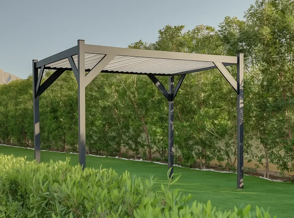 A modern, black metal sunroof pergola with a slatted roof stands on a manicured lawn, surrounded by lush green bushes and trees under a clear sky.
