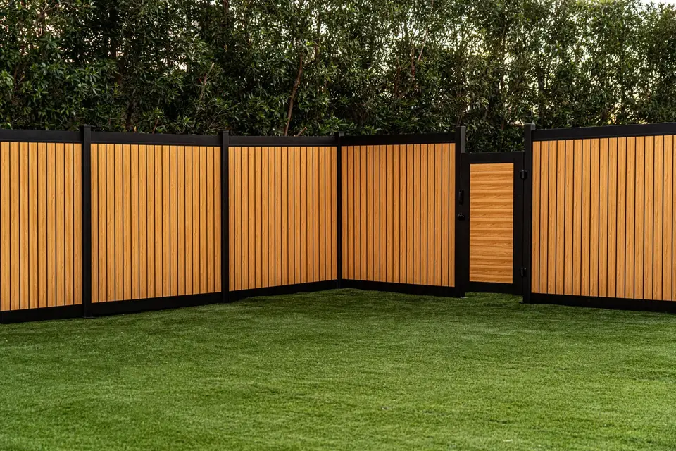 Vertical aluminum privacy fence with wood look.