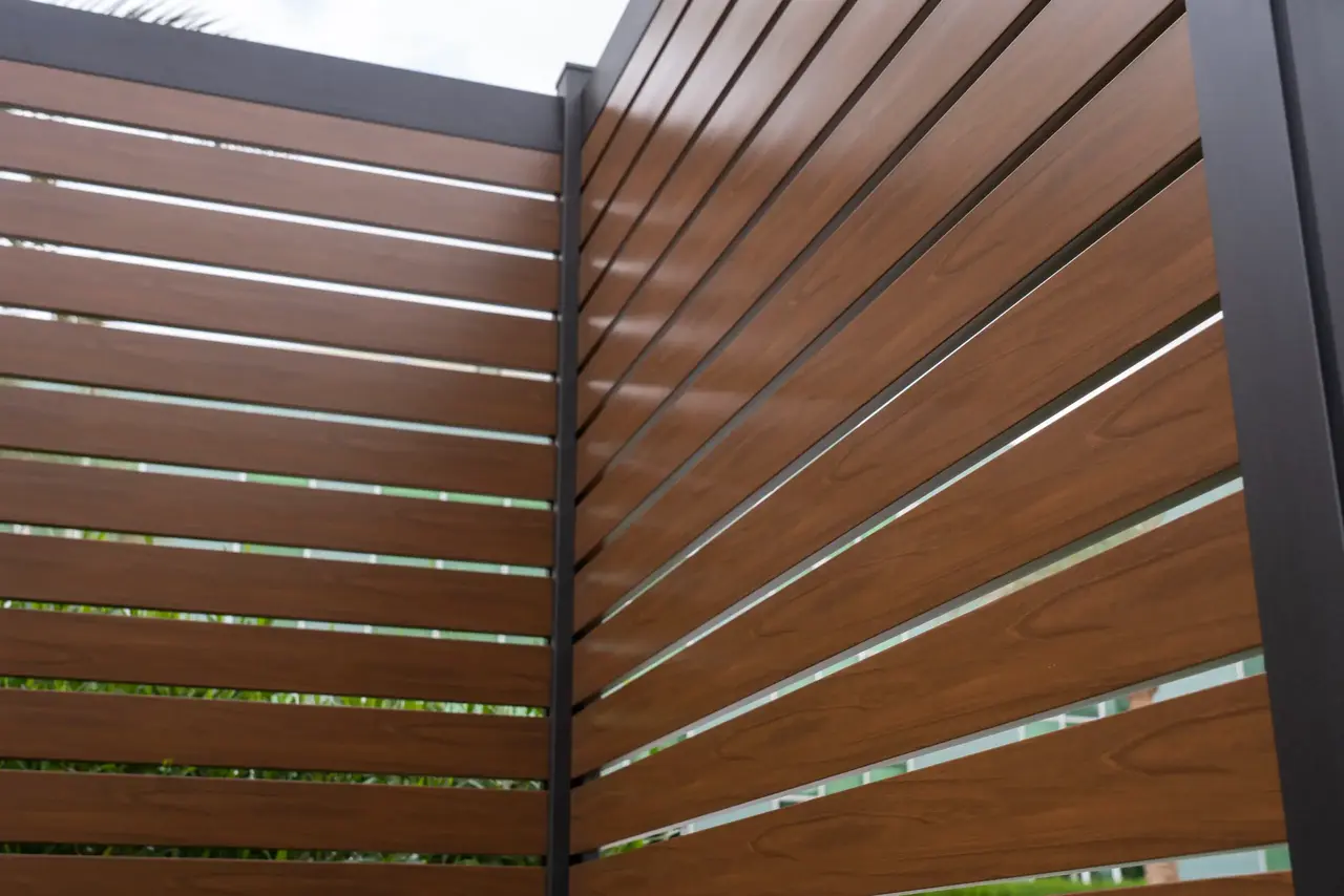 close up image of a semi privacy aluminum fence with wood appearance