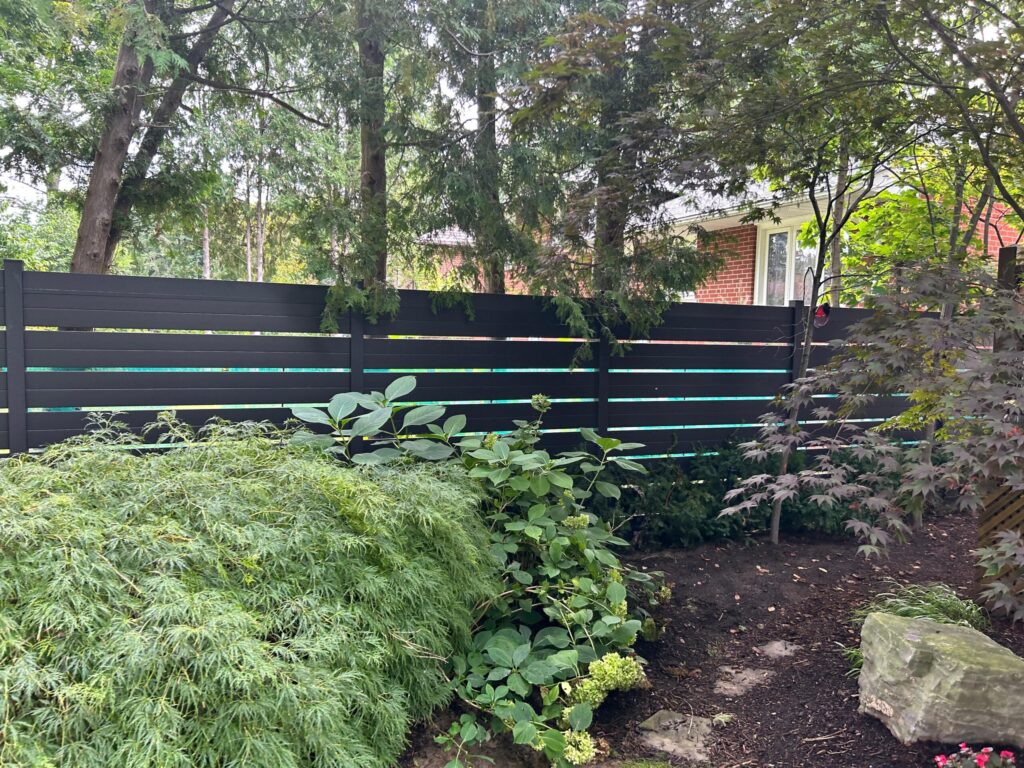 black semi private fence with plants around it in erindale mississauga