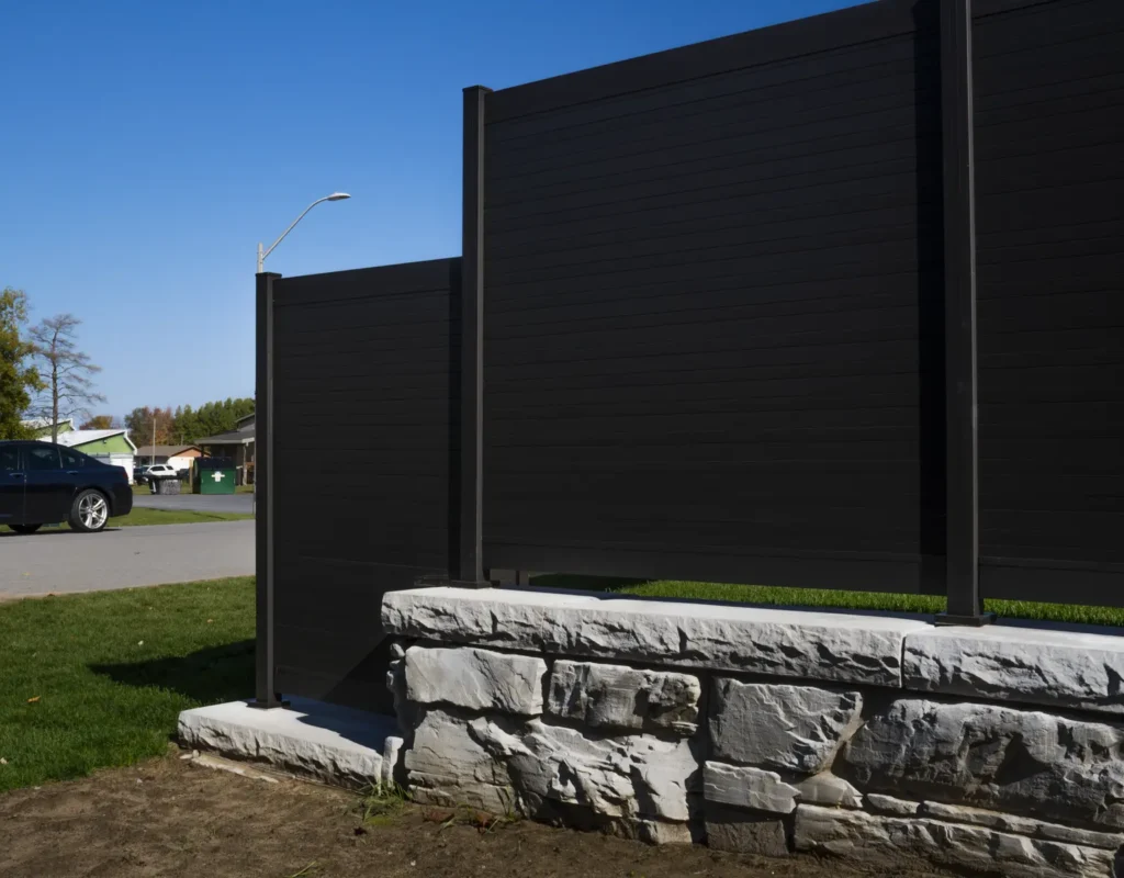 black privacy aluminum fence beside street