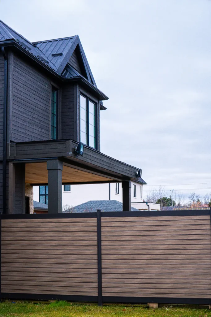 privacy plus primealux fence with a house behind it