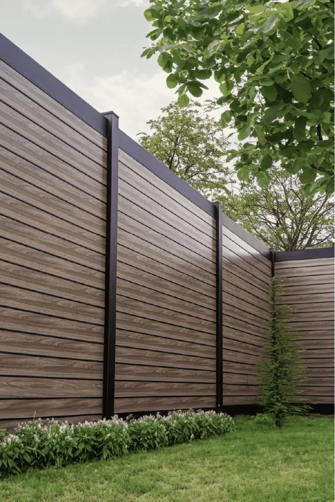 Privacy plus fence image with grass and trees